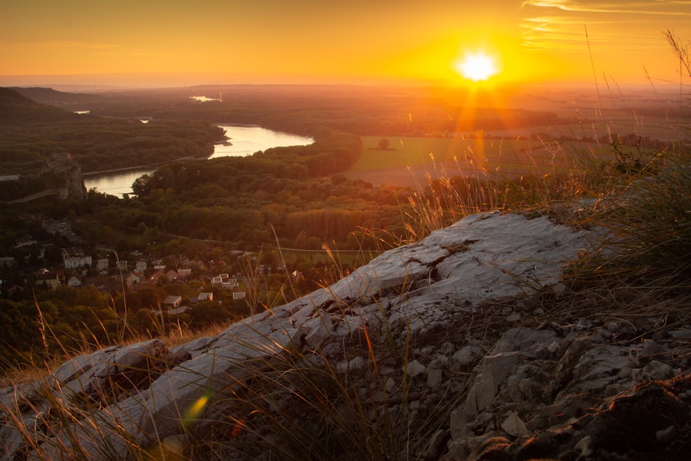 the sun is setting over a small town