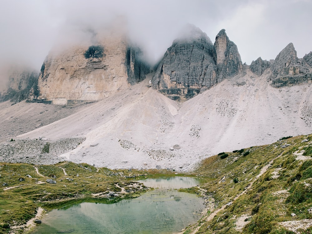 a mountain range with a lake in the foreground