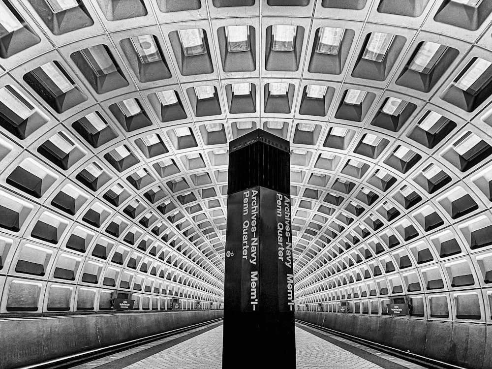 a black and white photo of a subway station