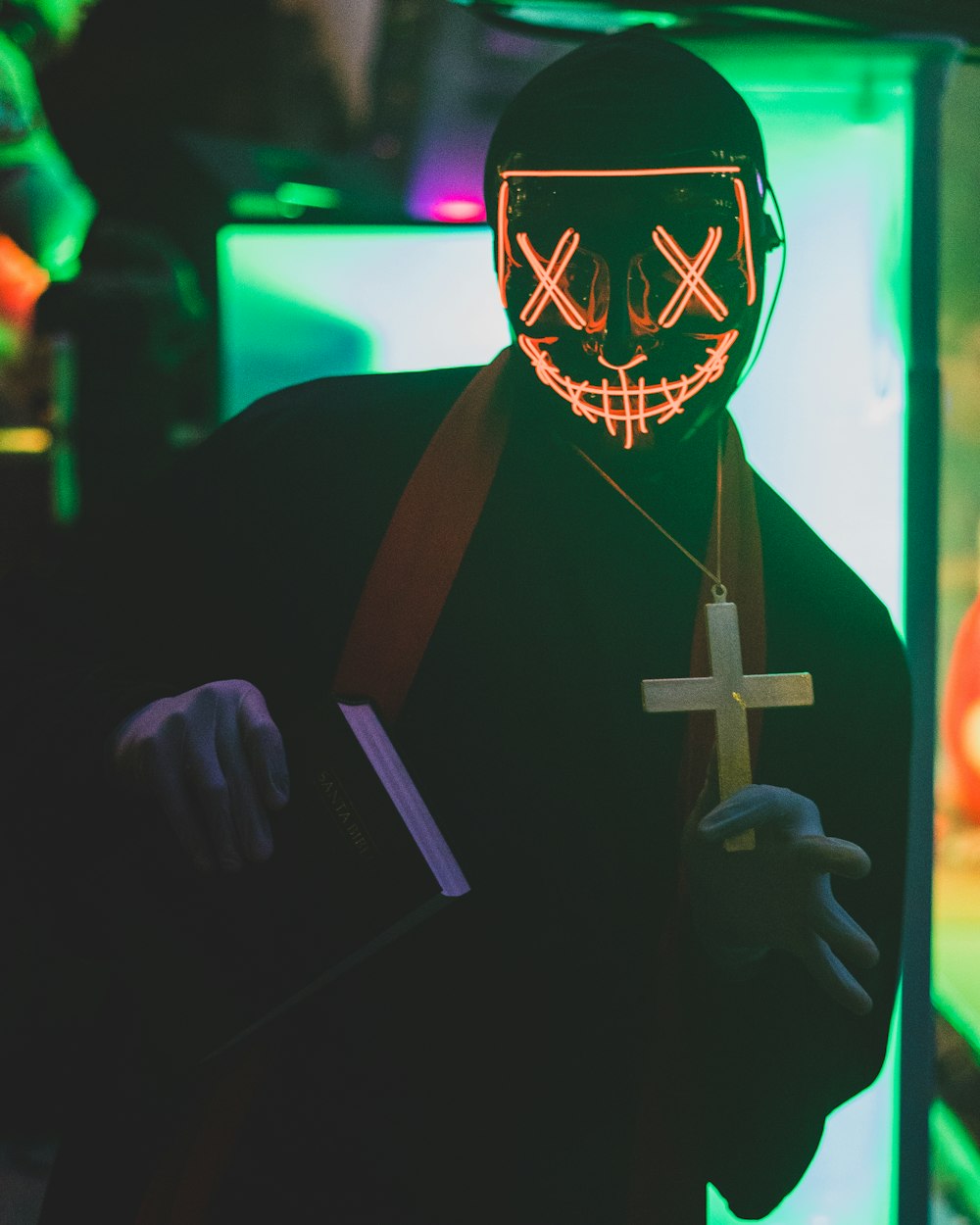 a person wearing a mask and holding a cross