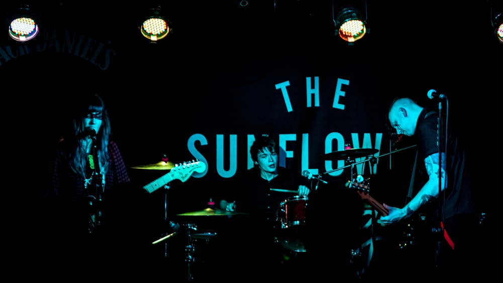 a band playing on stage in the dark