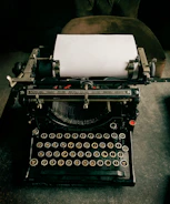 A vintage typewriter with a fresh sheet of paper ready for the next story.