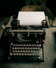 A vintage typewriter with a blank sheet of paper, representing the art of writing.