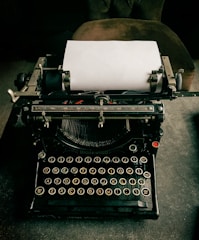 A vintage typewriter with fresh pages of articles ready to be published.