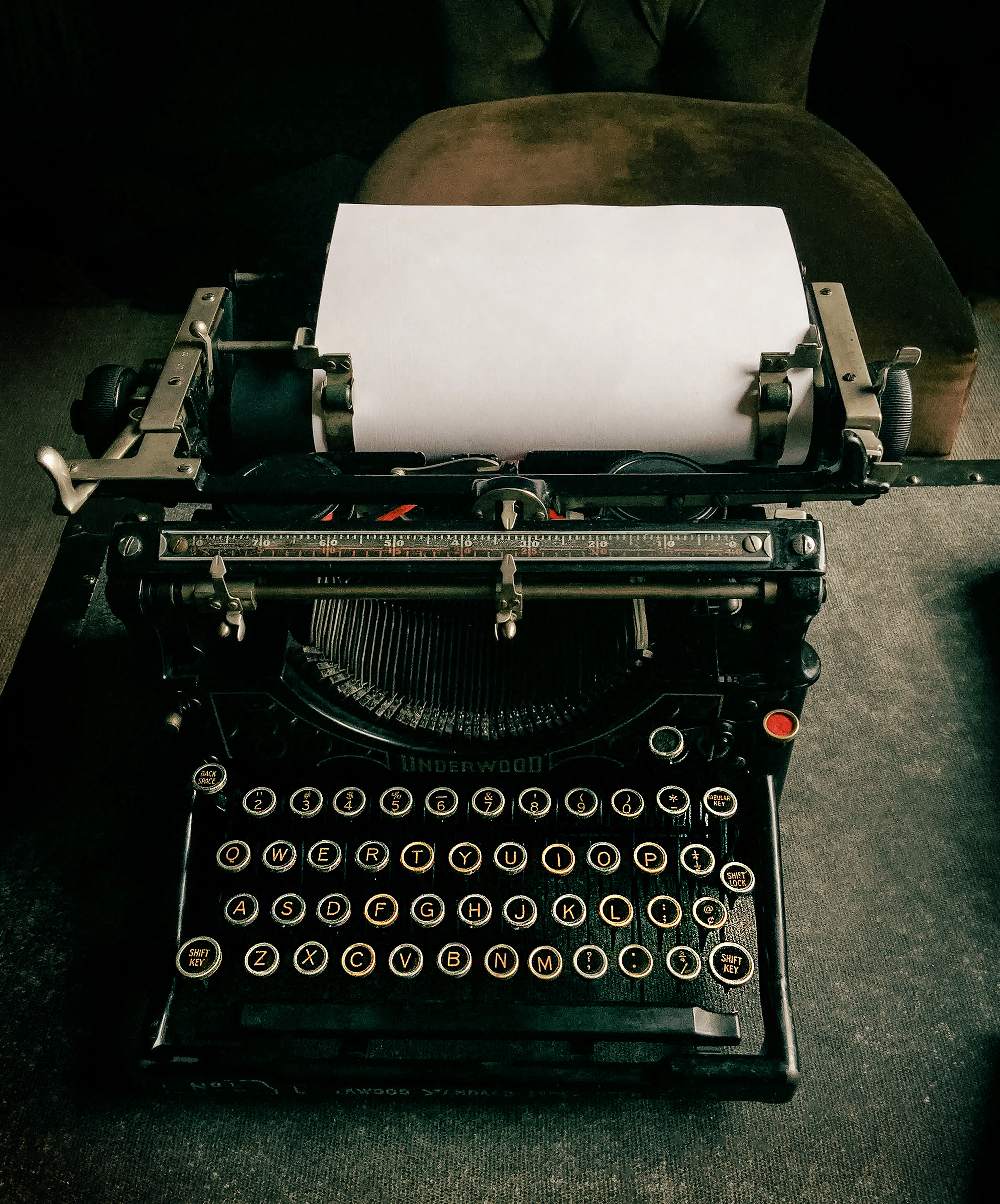 A vintage typewriter with a clean sheet of paper
