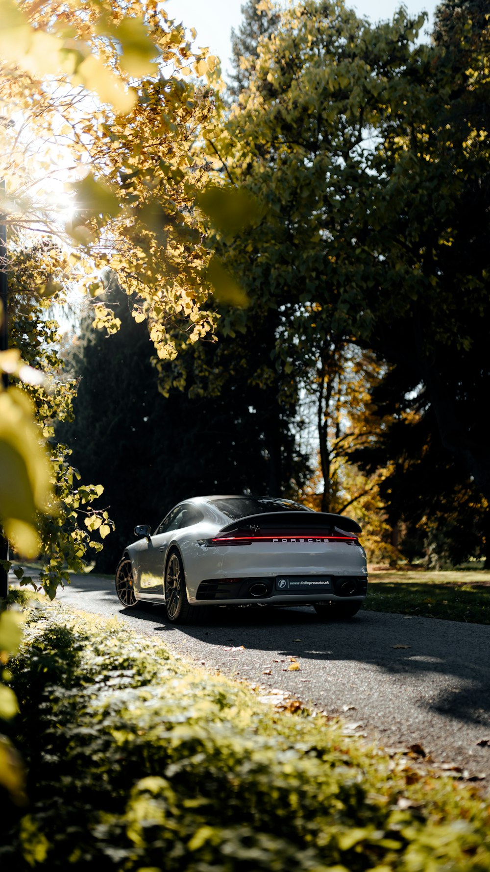 a white sports car parked on the side of a road