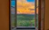 Sunset view from the living room window showing peaceful farmland and distant woods.