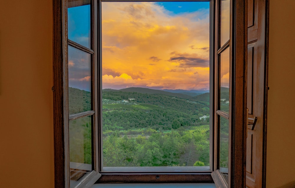 an open window with a view of the mountains