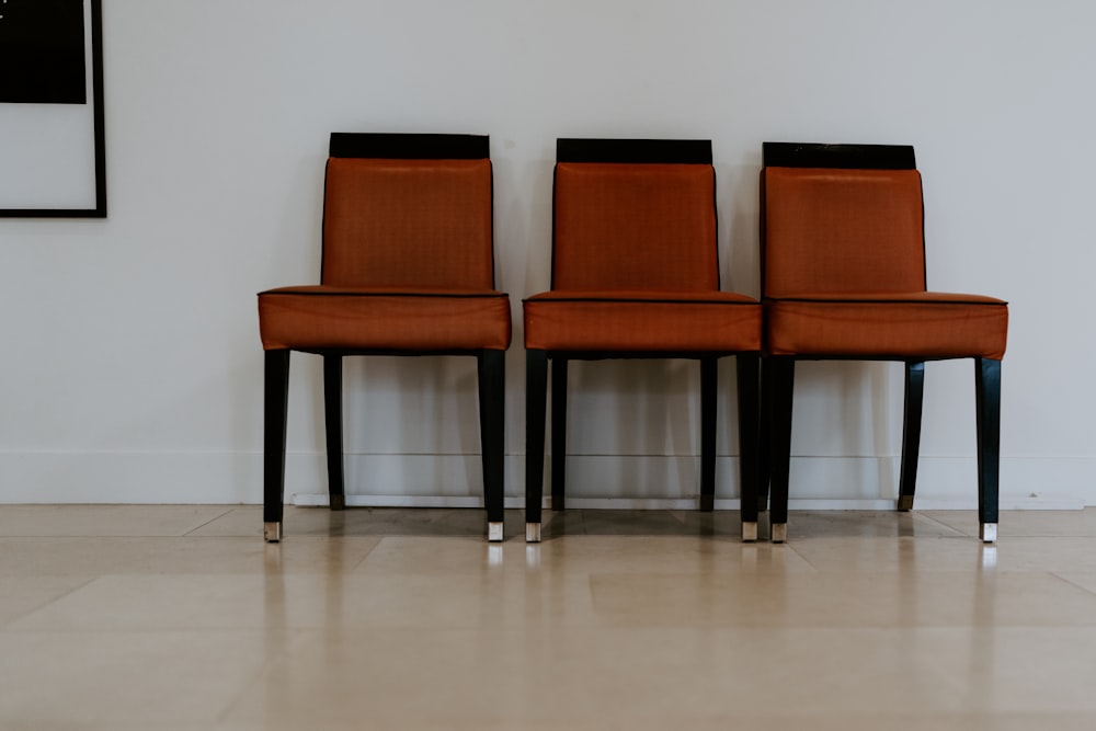 a couple of brown chairs sitting next to each other