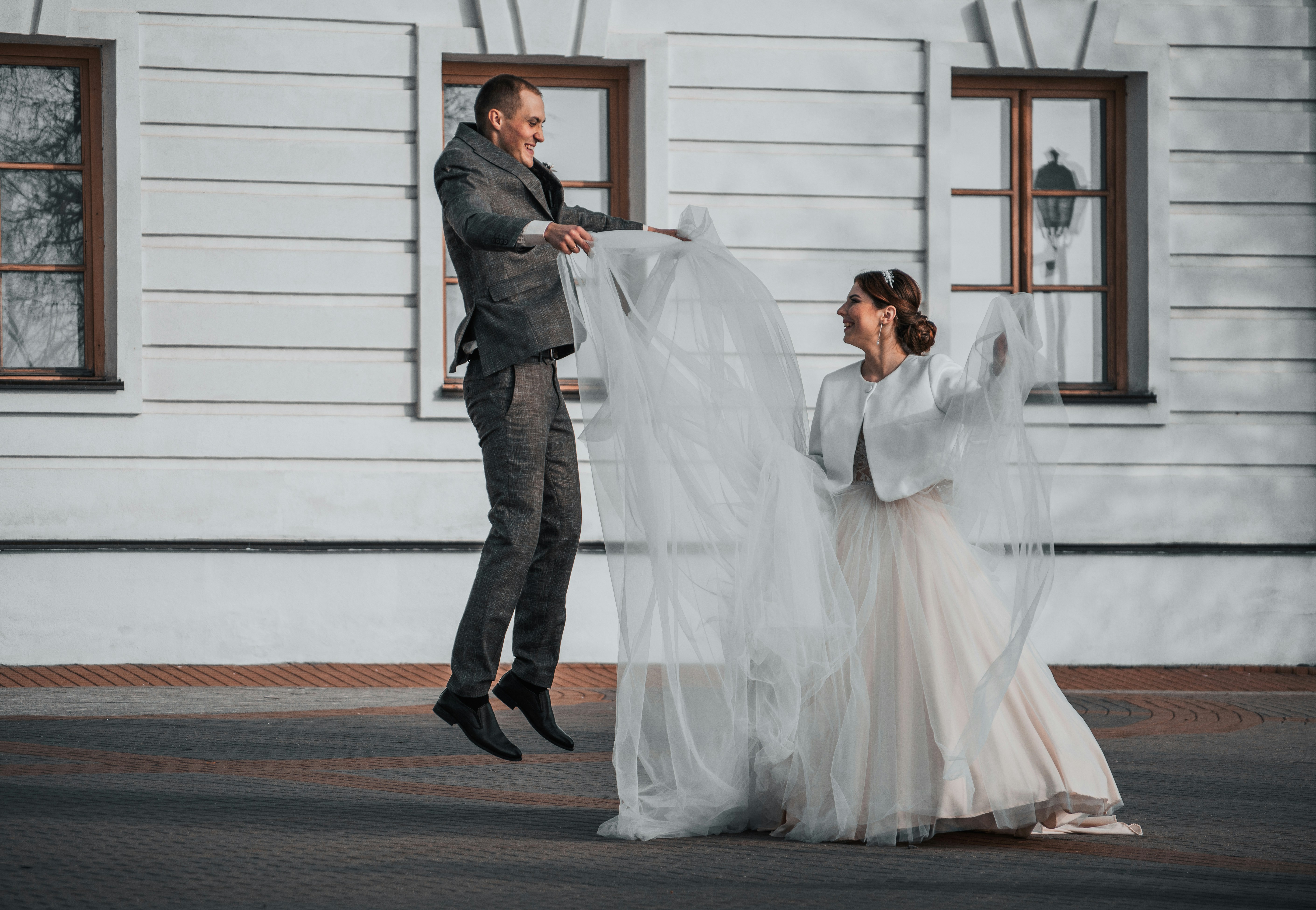 a man standing next to a woman in a wedding dress