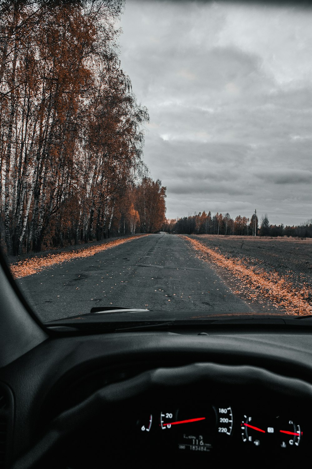 a car driving down a rural country road