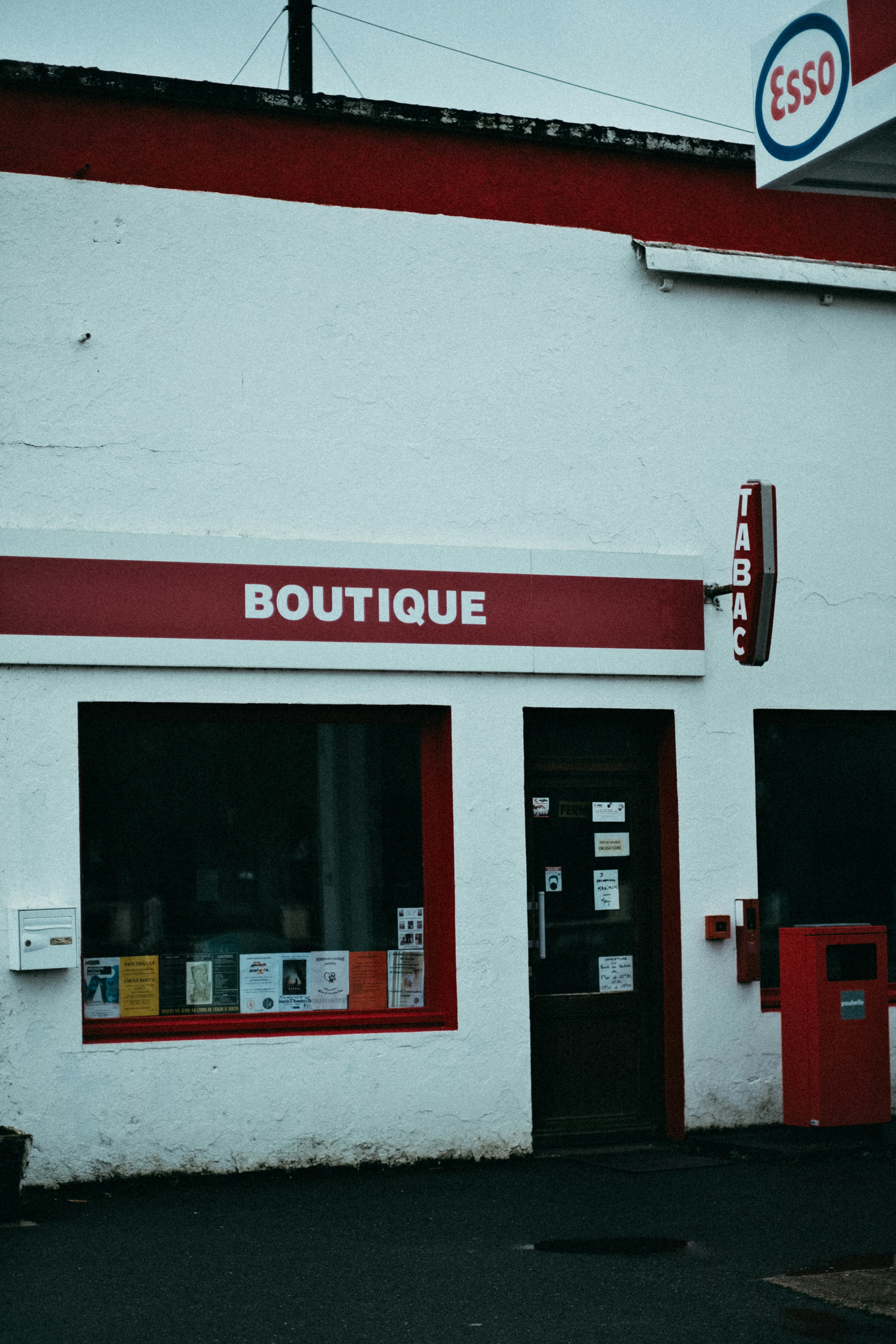 a white building with red trim and a red door