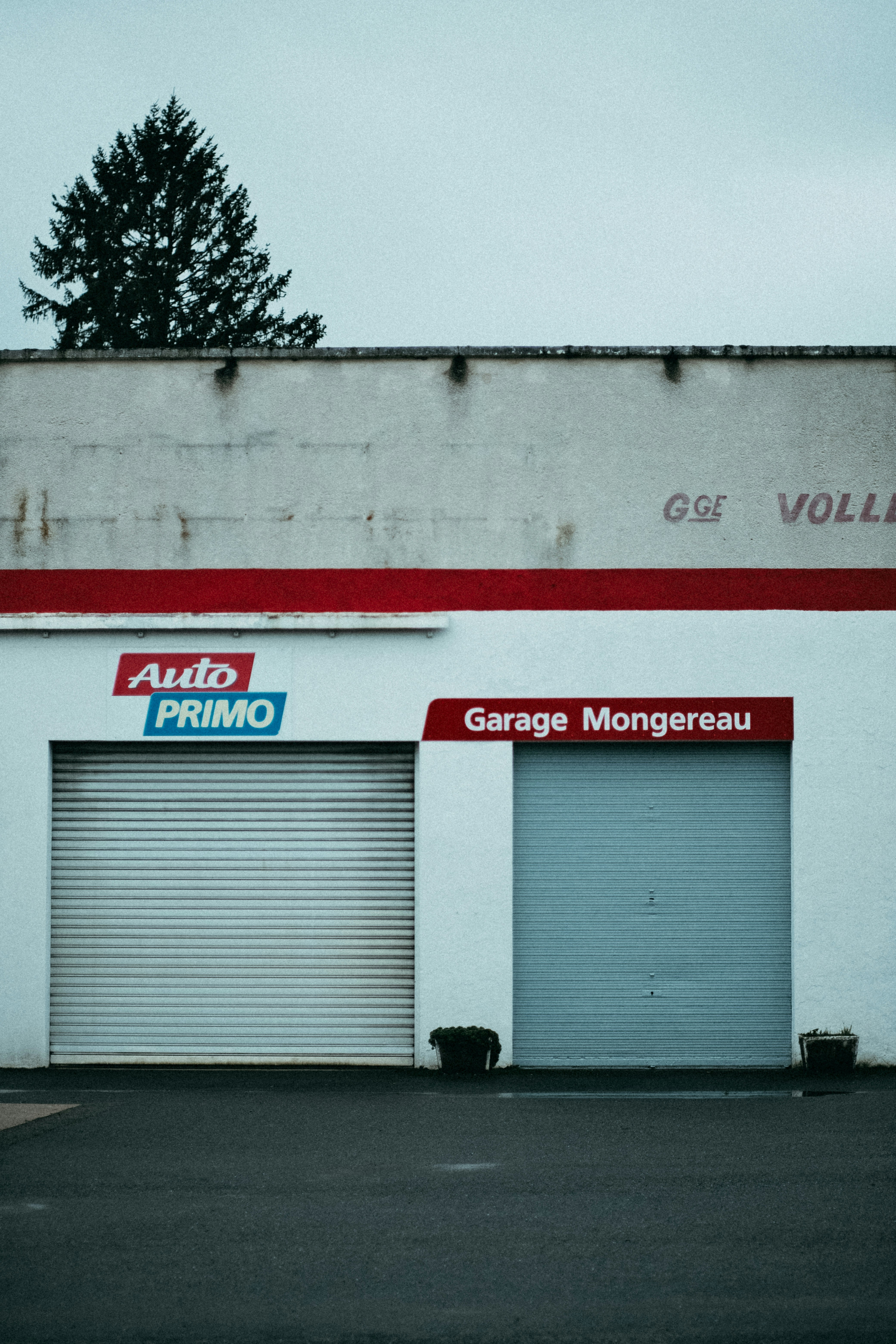 a garage with two garage doors and two garage doors