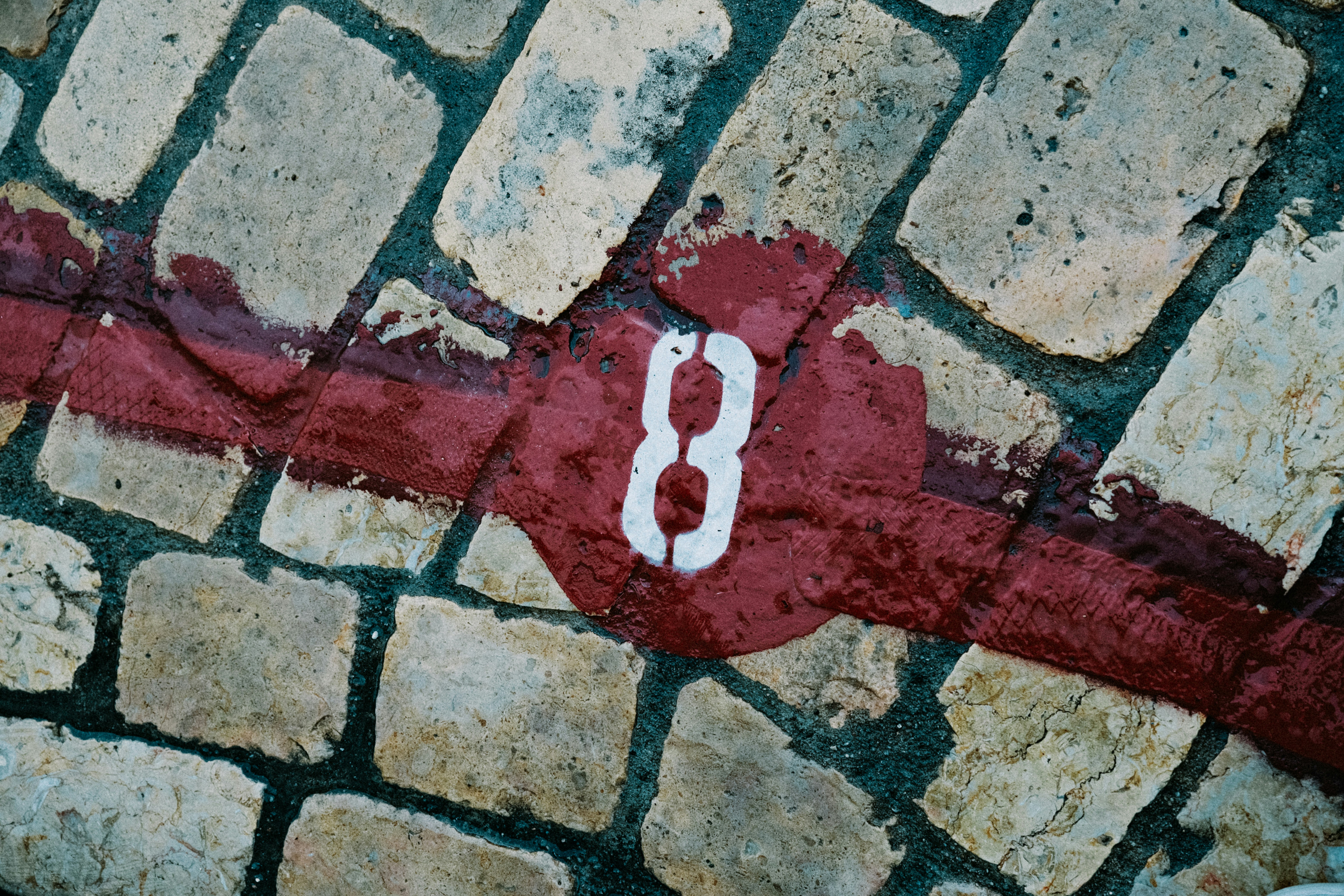 a close up of a street sign on a brick wall