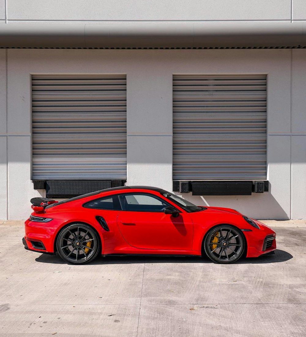 a red sports car parked in front of a building