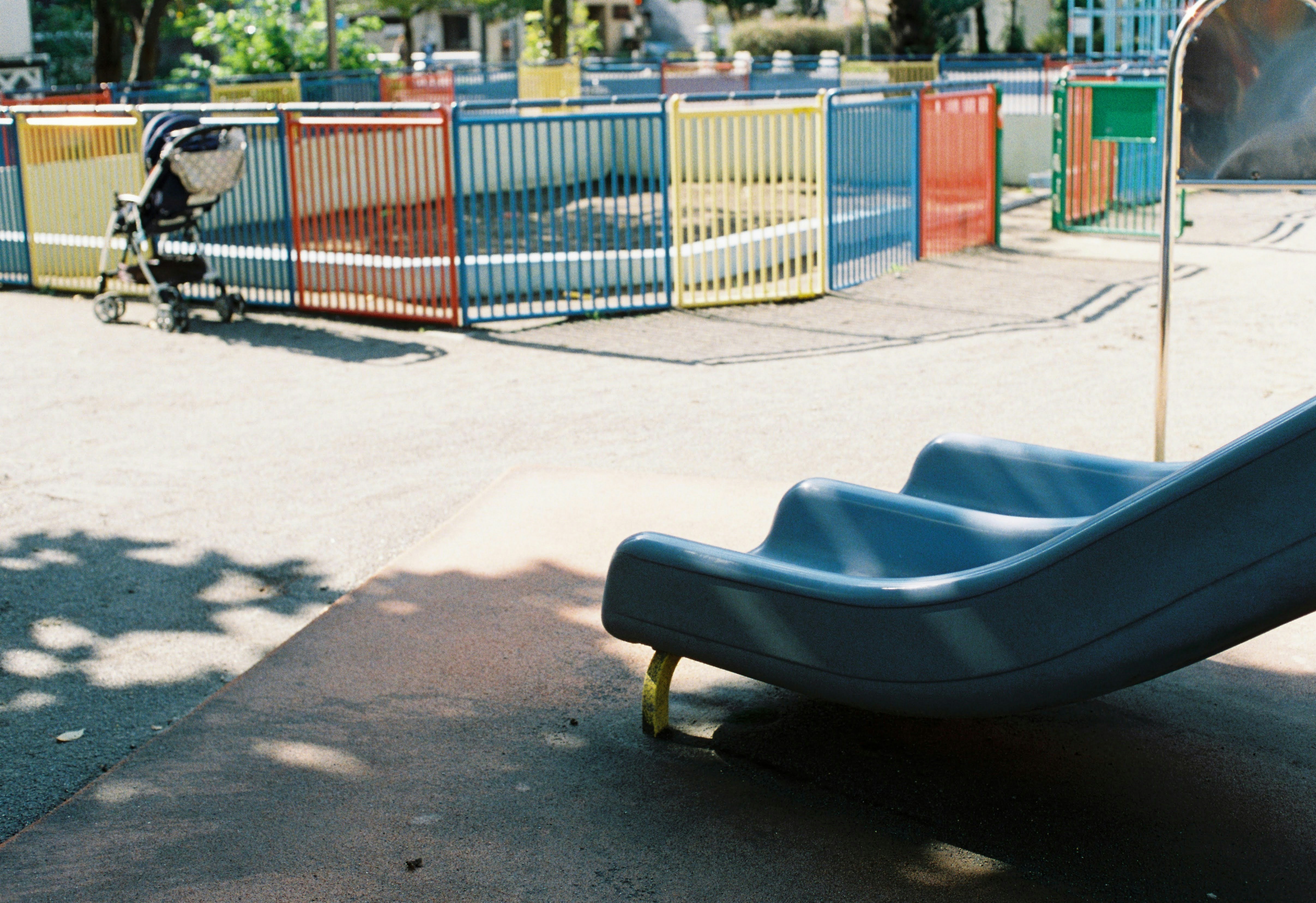 a playground with a slide and a bicycle in the background