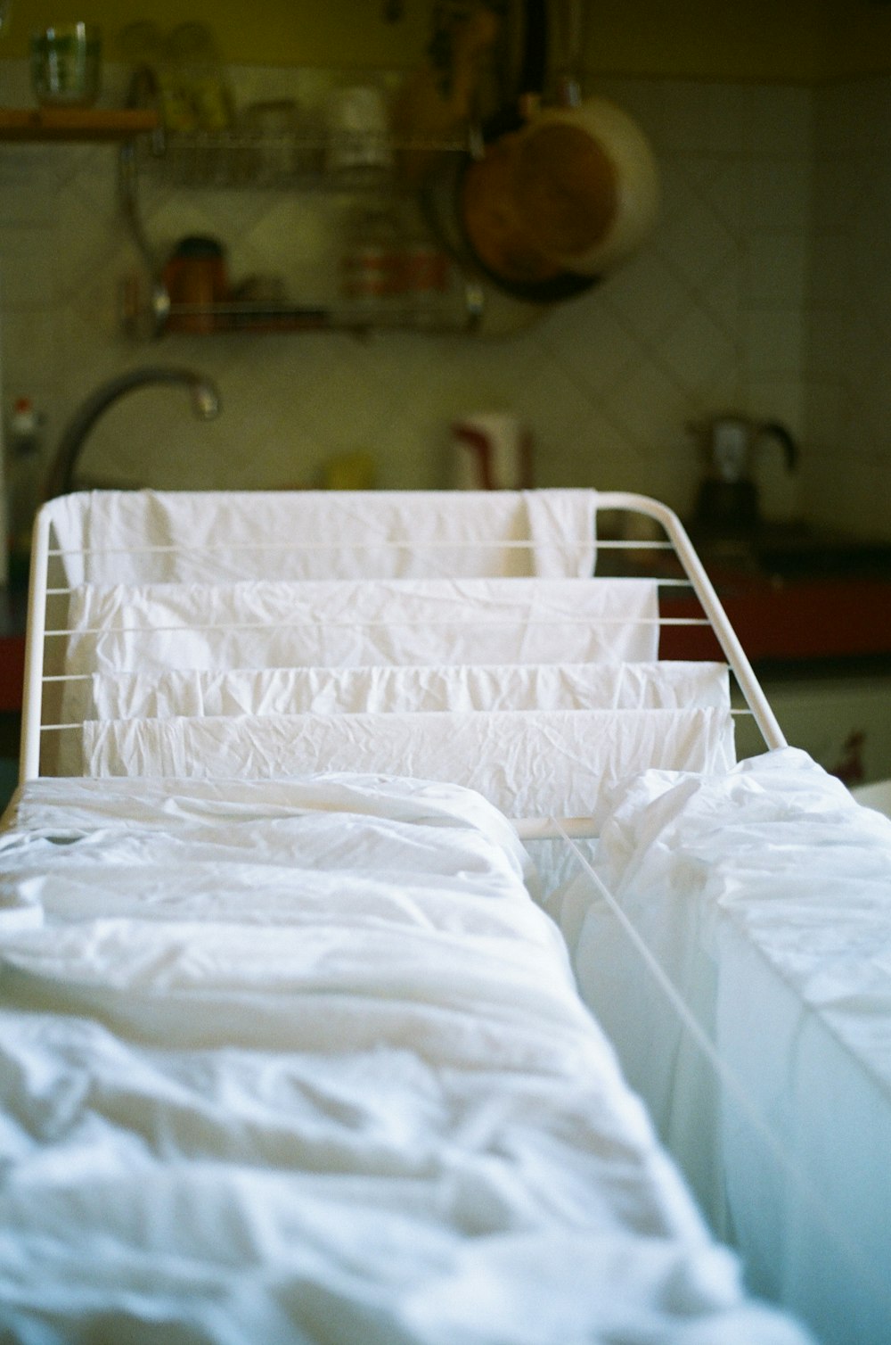 a hospital bed with white sheets in a room