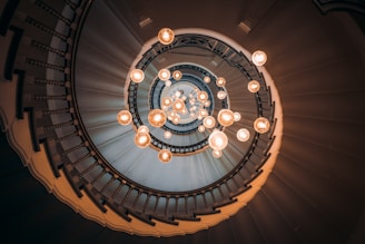 an overhead view of a spiral staircase with lights