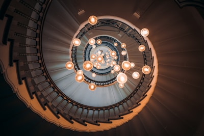 an overhead view of a spiral staircase with lights