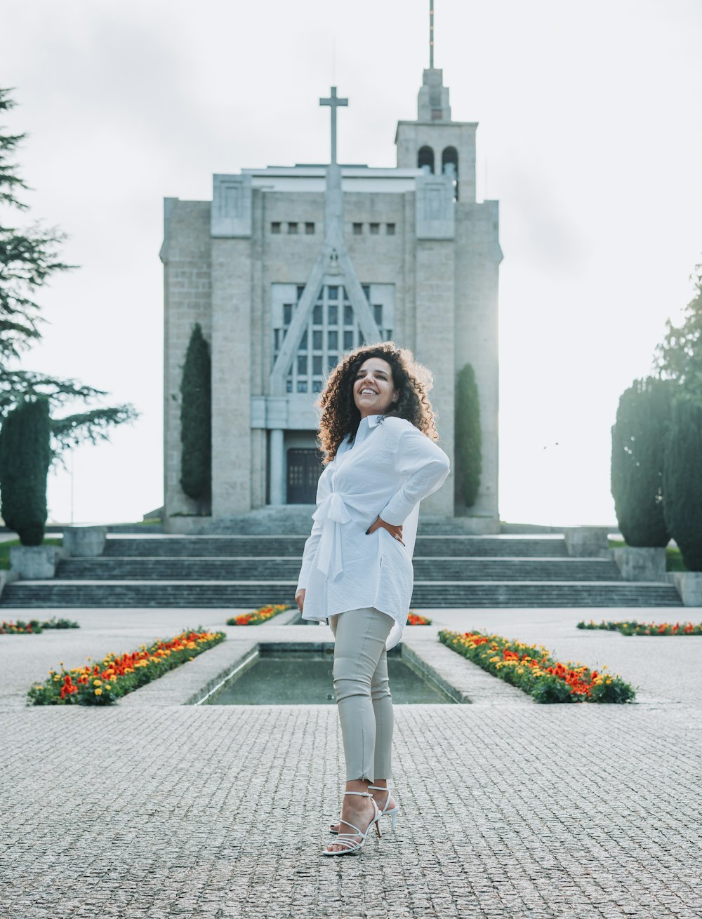 a woman standing in front of a church