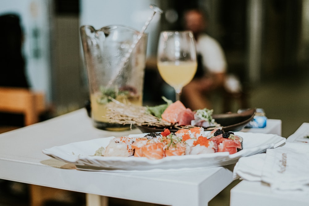 a plate of food and a glass of wine on a table