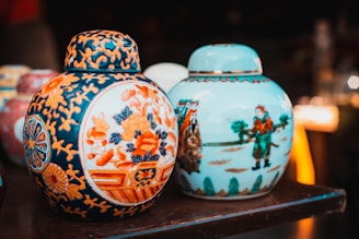 a couple of Chinese ceramic vases that are sitting on a table