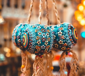 a close up of a bunch of bells hanging from a ceiling