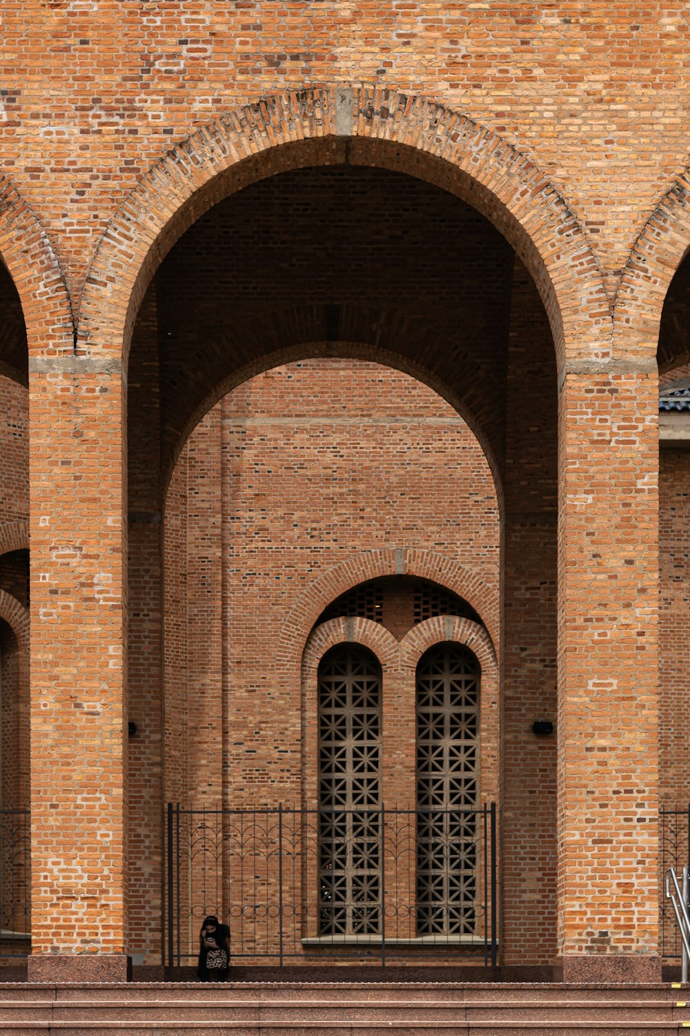 a person sitting on a bench in front of a building