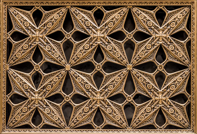 Close-up of the gilded decorative ironwork grate inside the Rookery Building in Chicago