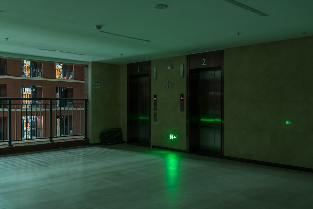 an empty room with a green light on the floor