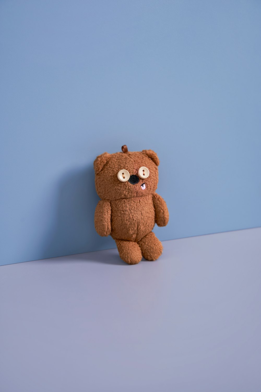 a brown teddy bear sitting on top of a table