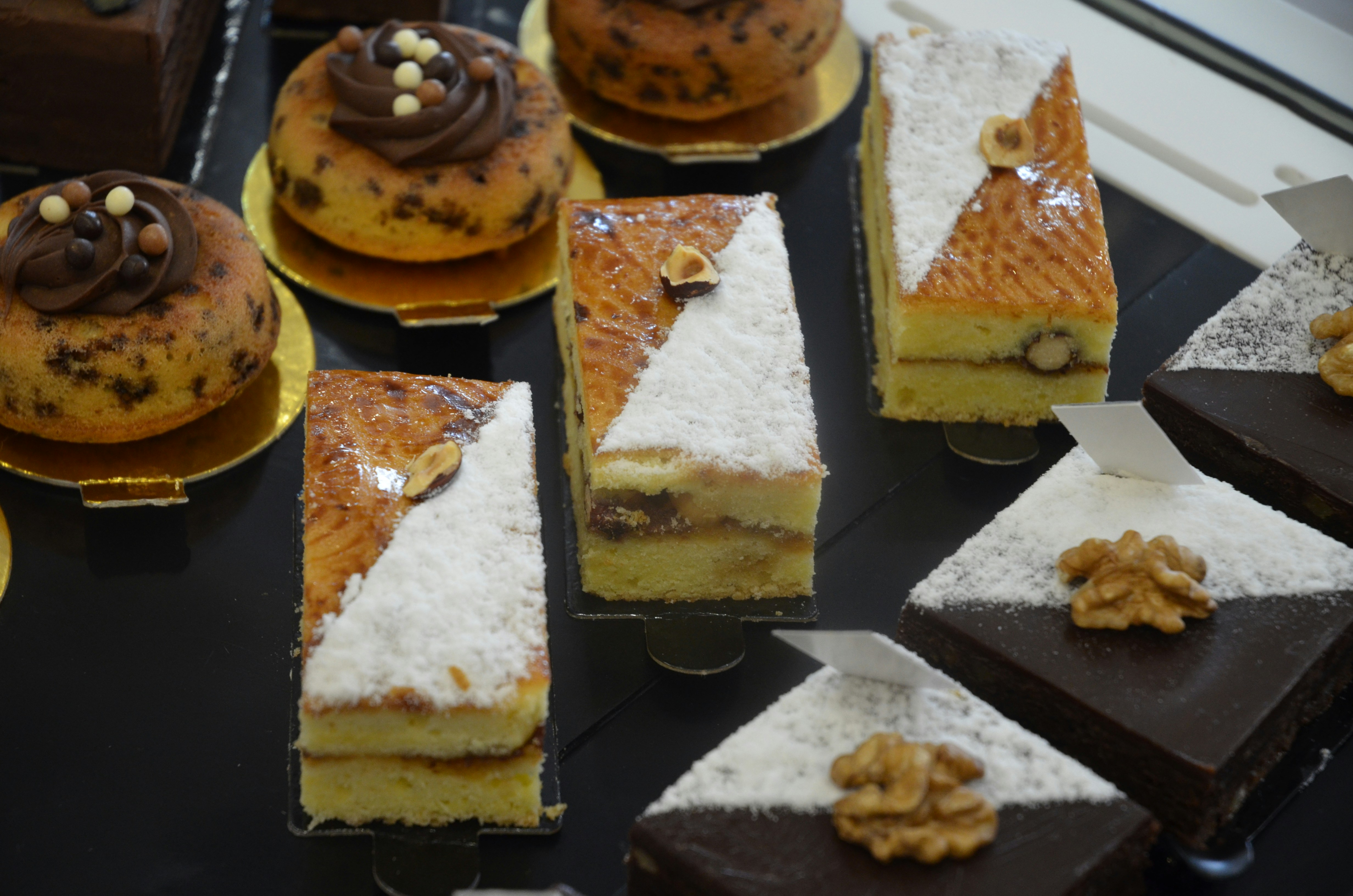 a table topped with lots of different types of cakes
