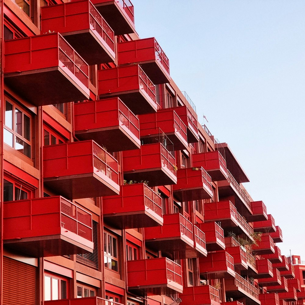 a tall red building with balconies and balconies