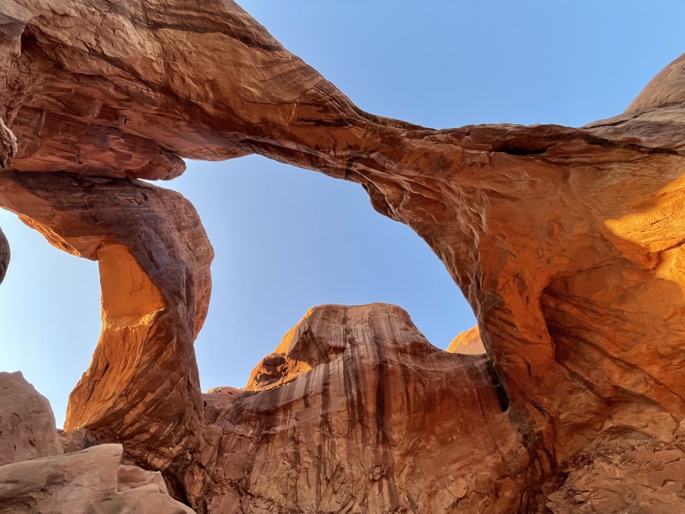 a large rock formation with a sky in the background