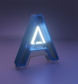 Large illuminated letter 'A' standing on a wooden floor at a party venue.