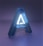 A large, three-dimensional letter 'A' with a glowing interior set against a dimly lit blue and purple background. The letter has a modern and sleek design, with an illuminated white core surrounded by a blue translucent exterior.