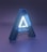 A large, three-dimensional letter 'A' with a glowing interior set against a dimly lit blue and purple background. The letter has a modern and sleek design, with an illuminated white core surrounded by a blue translucent exterior.