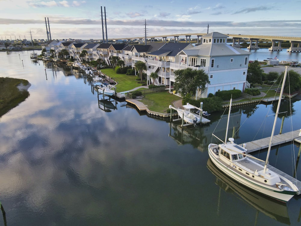 a boat is docked in the water next to houses