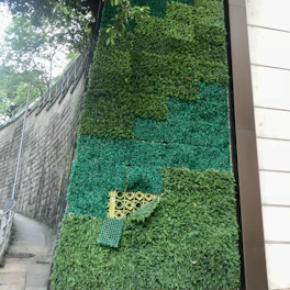 Vertical garden wall bursting with colorful artificial plants