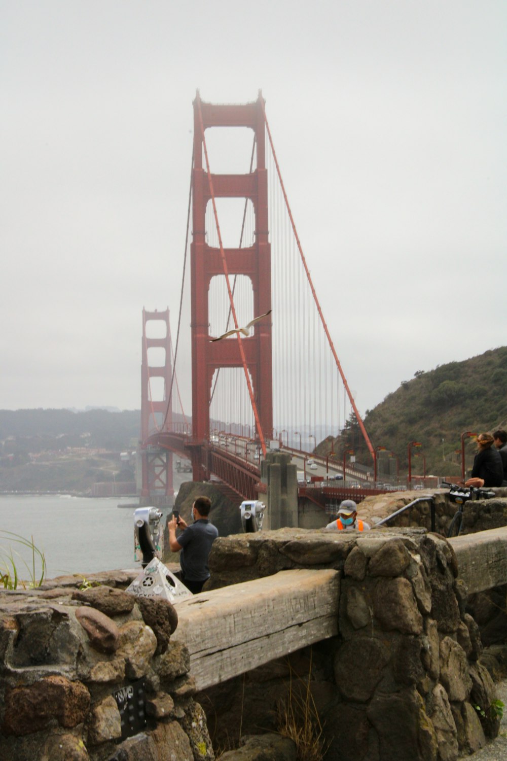 a group of people taking pictures of a bridge