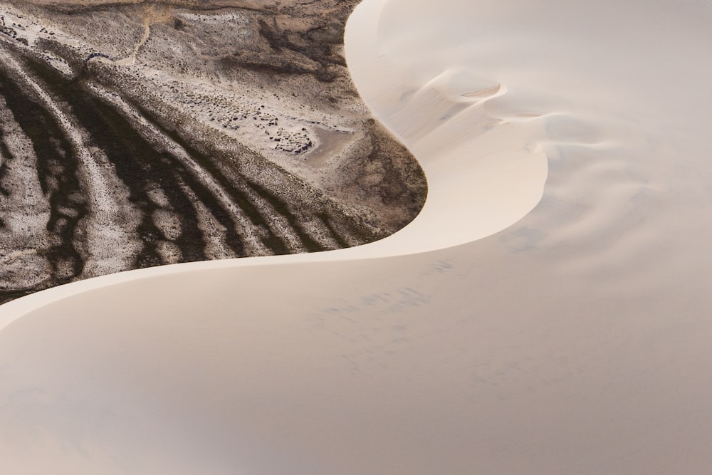 an aerial view of a white sand dune