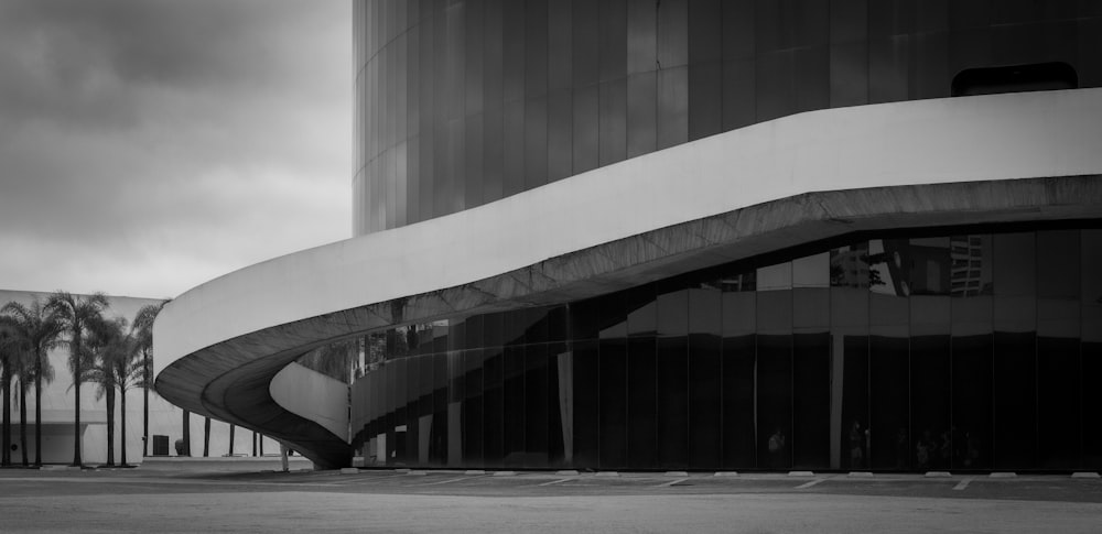 a black and white photo of a building with palm trees