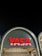 A modern architectural structure featuring an illuminated sign with the word 'YASA' in bold red letters. The sign is mounted on an arched facade that has a sleek, contemporary design with soft lighting accentuating its curves. The night sky provides a contrasting dark backdrop.