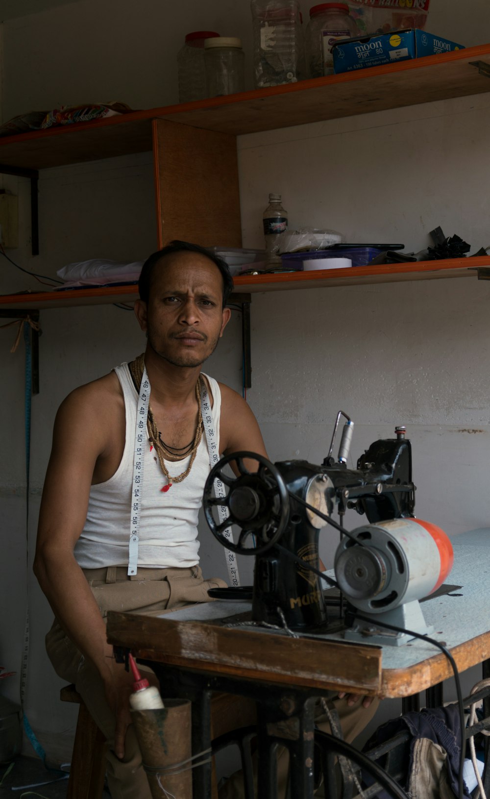 a man standing in front of a sewing machine