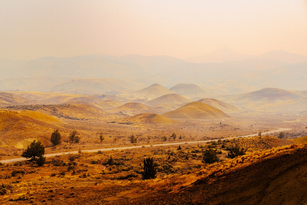 a scenic view of mountains and a road