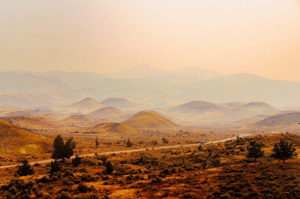 a scenic view of mountains and a road