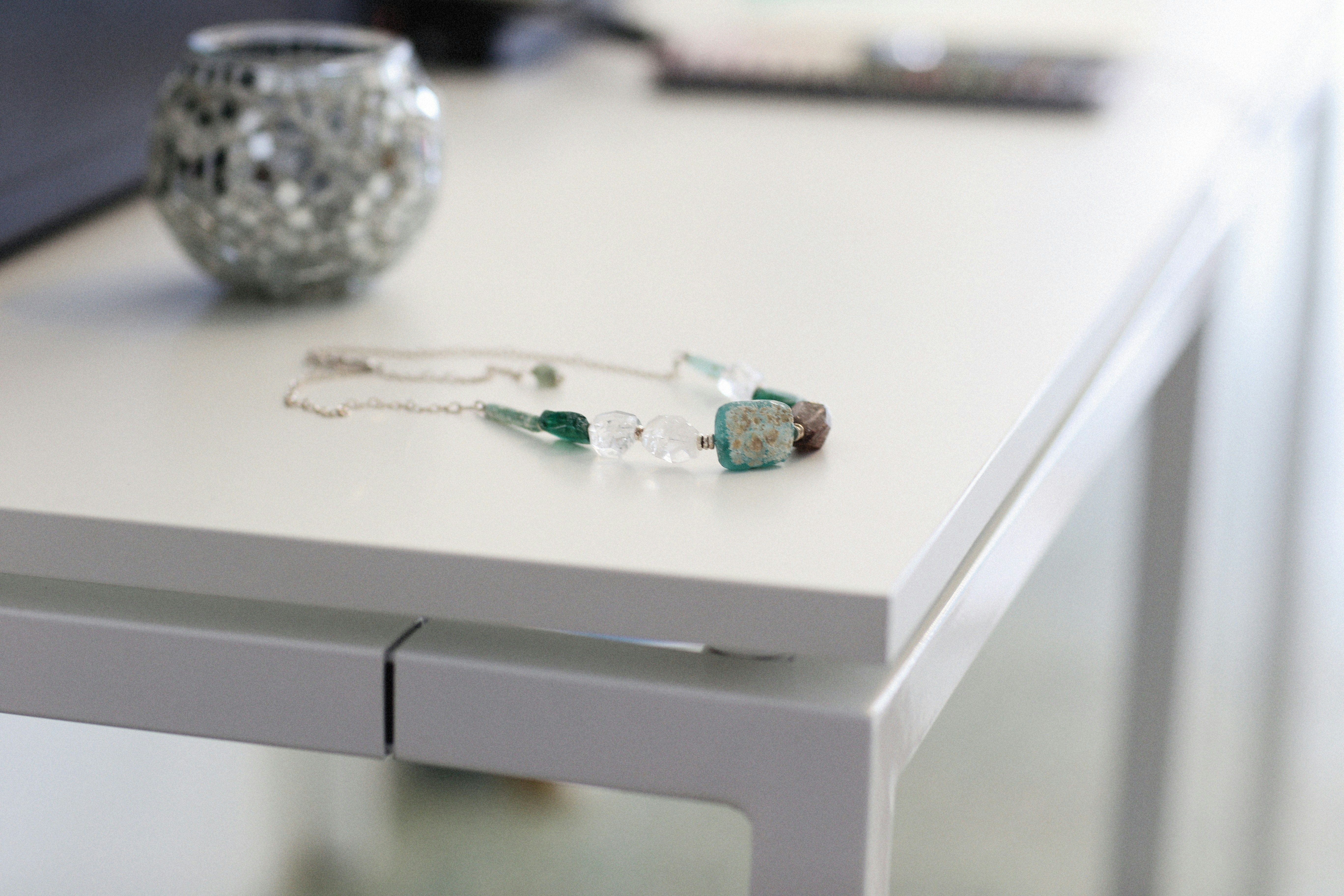 Close up of a table with a necklace