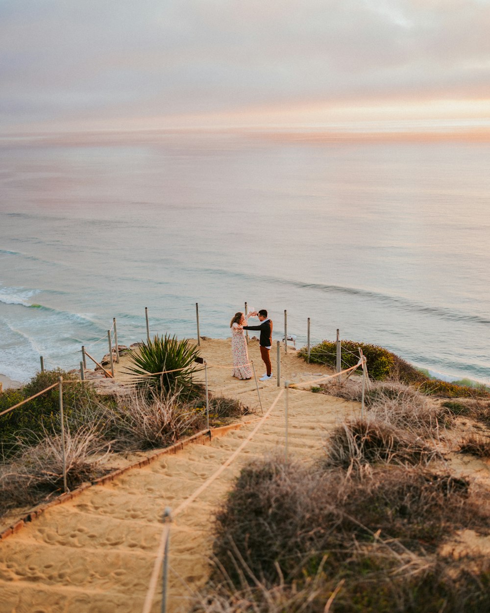 a couple of people that are standing on a beach