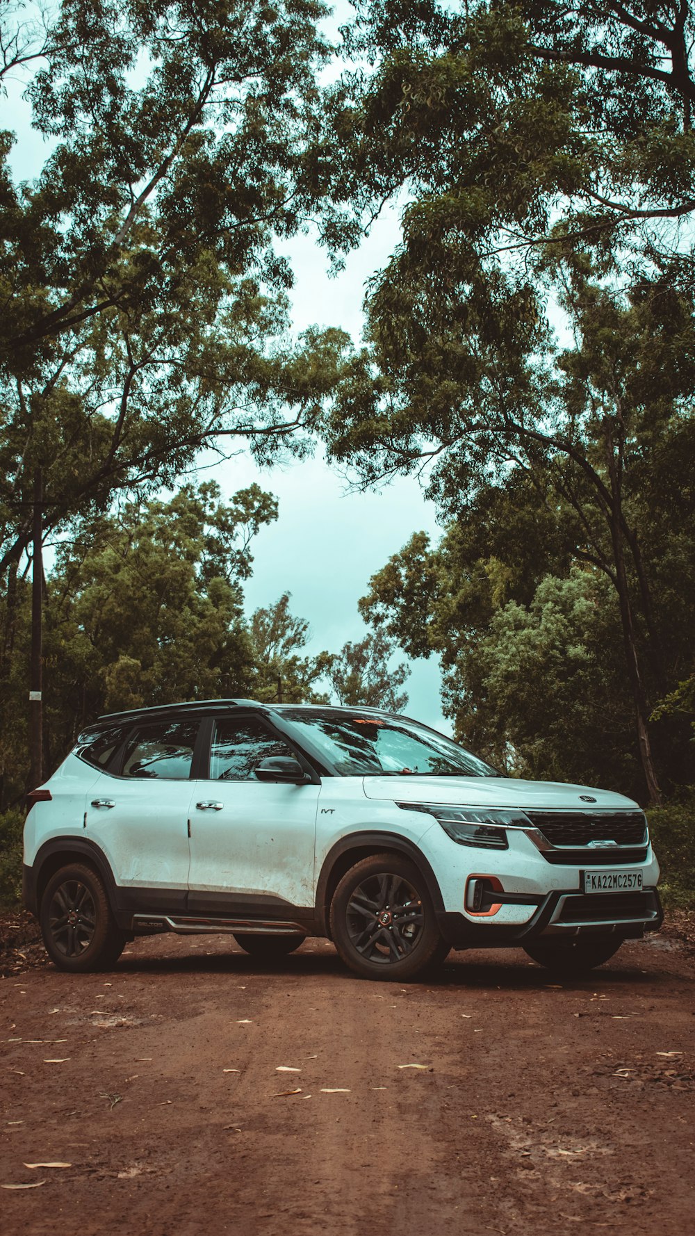 a white car parked on a dirt road