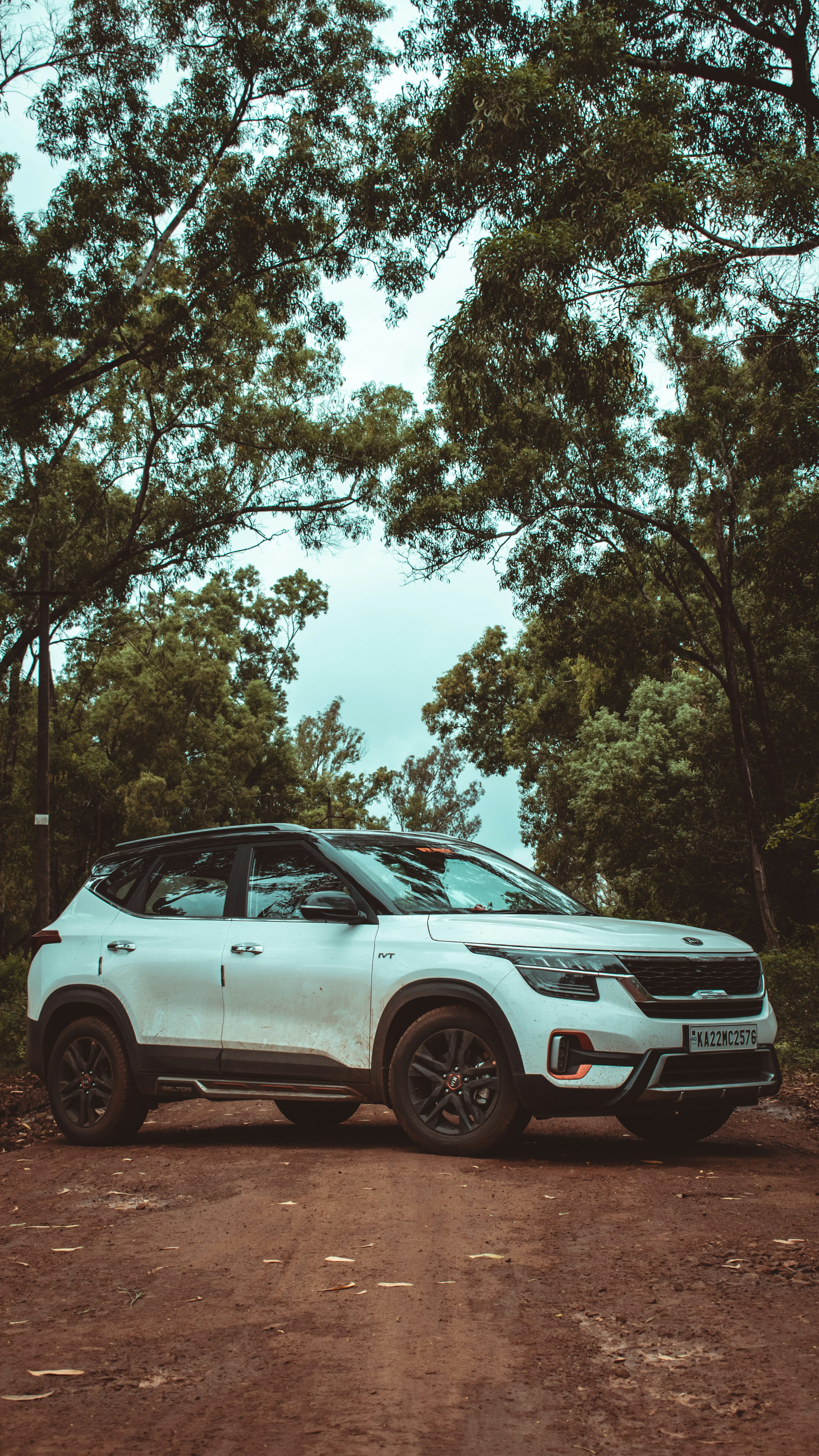 a white car parked on a dirt road